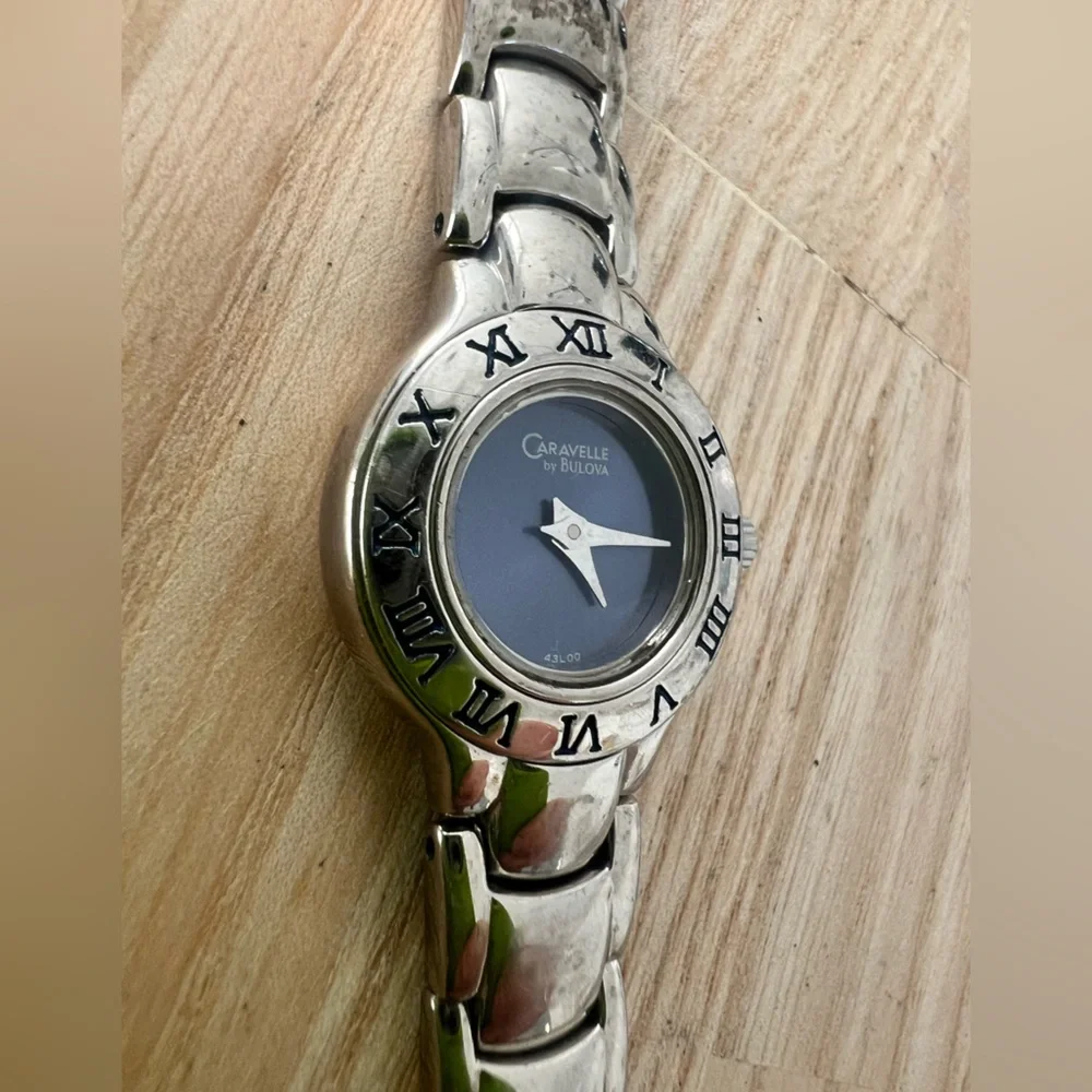 Caravelle by Bulova ladies blue dial silver tone dress watch NEW BATTERY